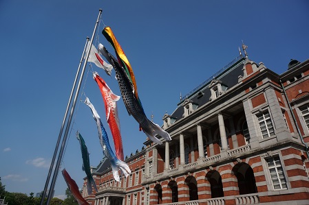 Red Brick Building with carp streamers in the late spring sky